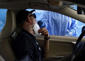 A healthcare worker takes a nasal swab sample to test for Covid-19 at a Total Testing Solutions Covid Testing Center in Los Angeles, Aug. 31, 2023.